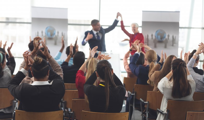 Rear View Of Diverse Business People Applauding KLDXWE4